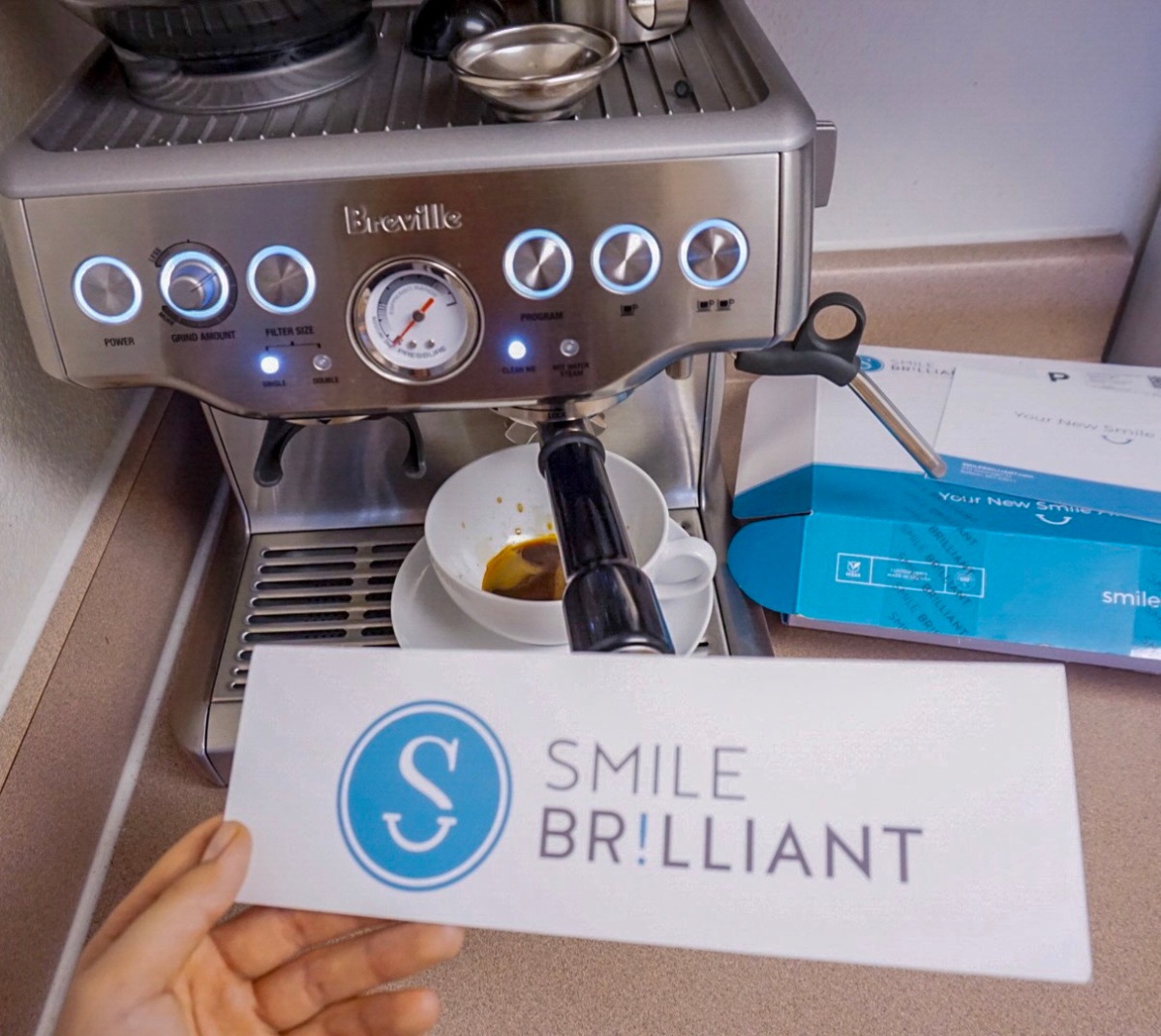 Cup of coffee with Smile Brilliant Teeth Whitening  